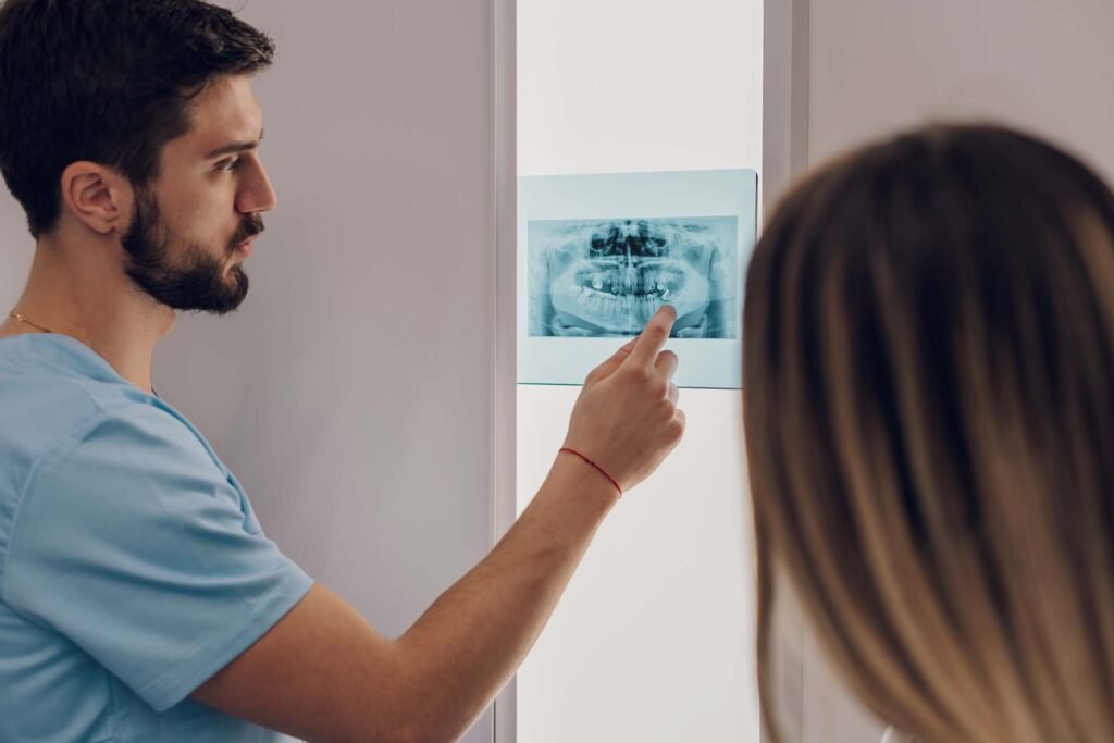 group-of-doctors-looking-at-x-ray-image-from-jaw-KW3B2PG.jpg